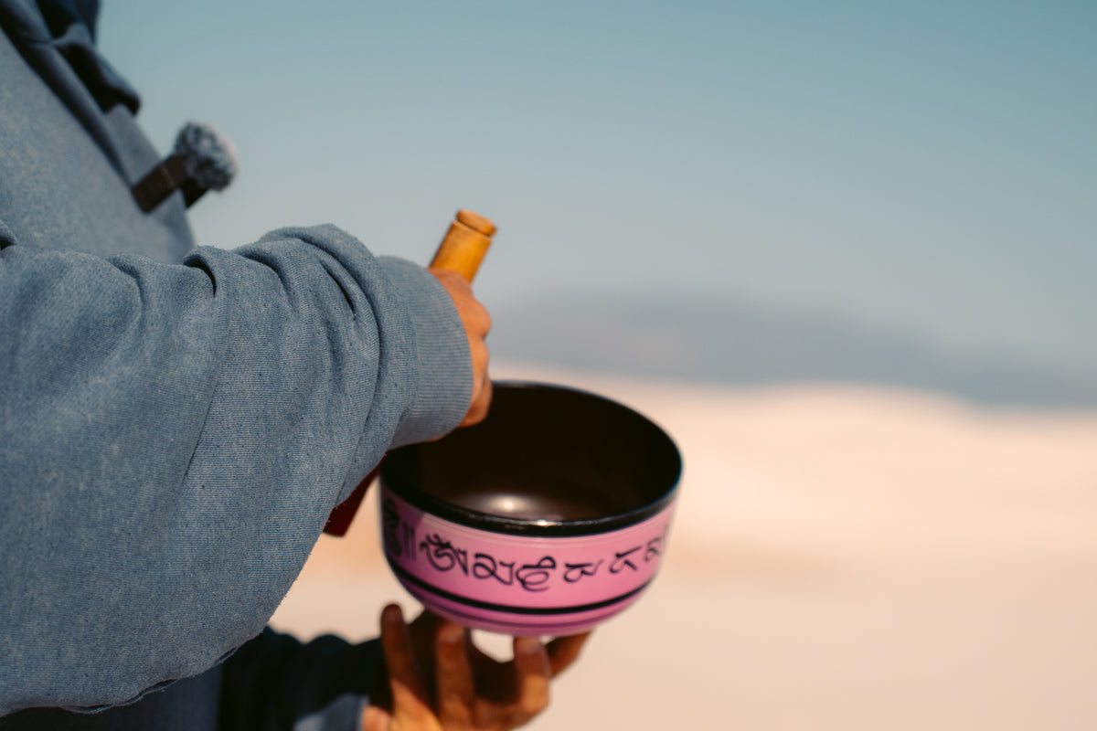Person playing a singing bowl